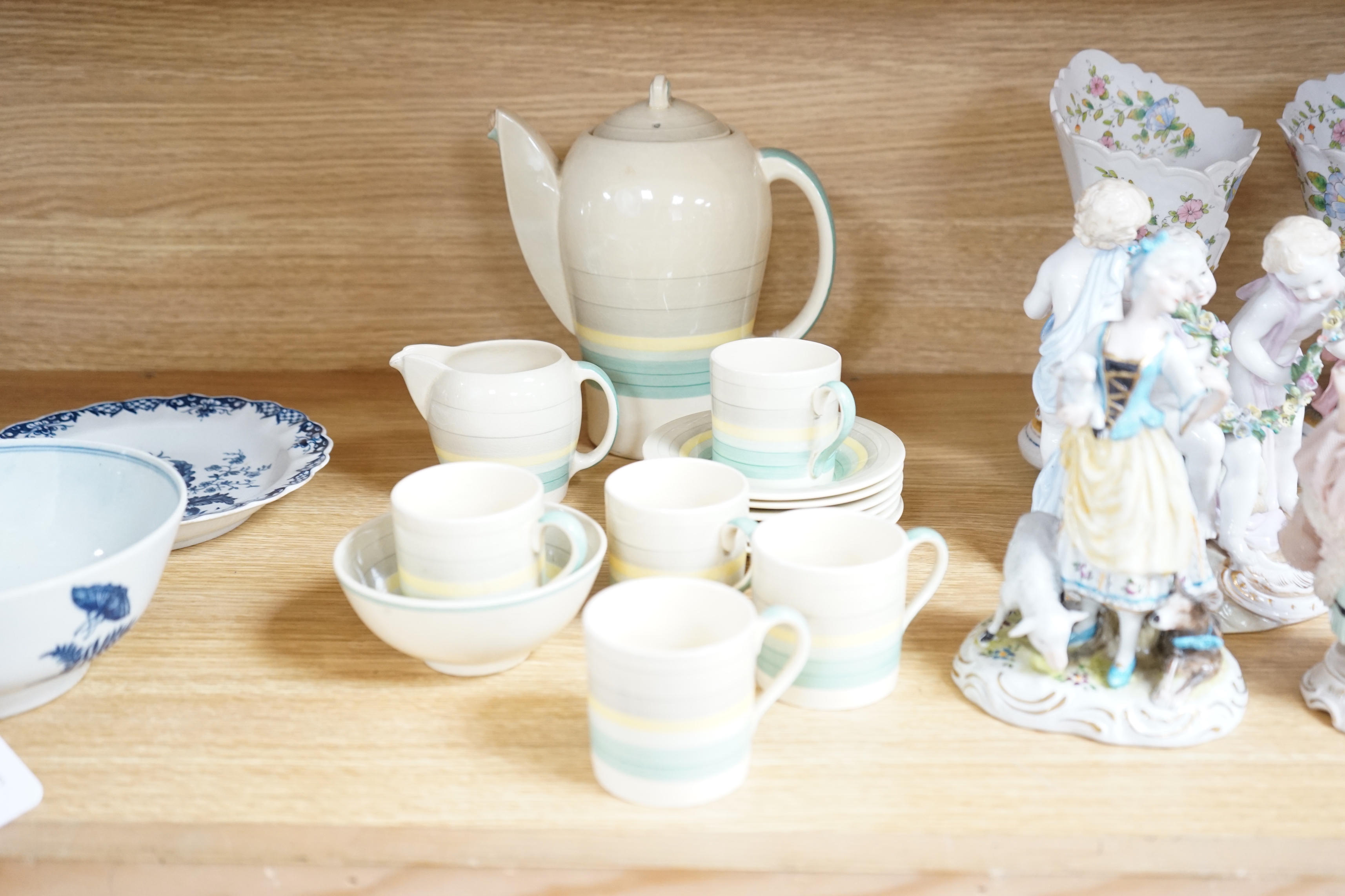 A Susie Cooper coffee set, concentric circles on a cream ground, comprising a coffee pot, milk jug, sugar bowl, five cups and six saucers (14)